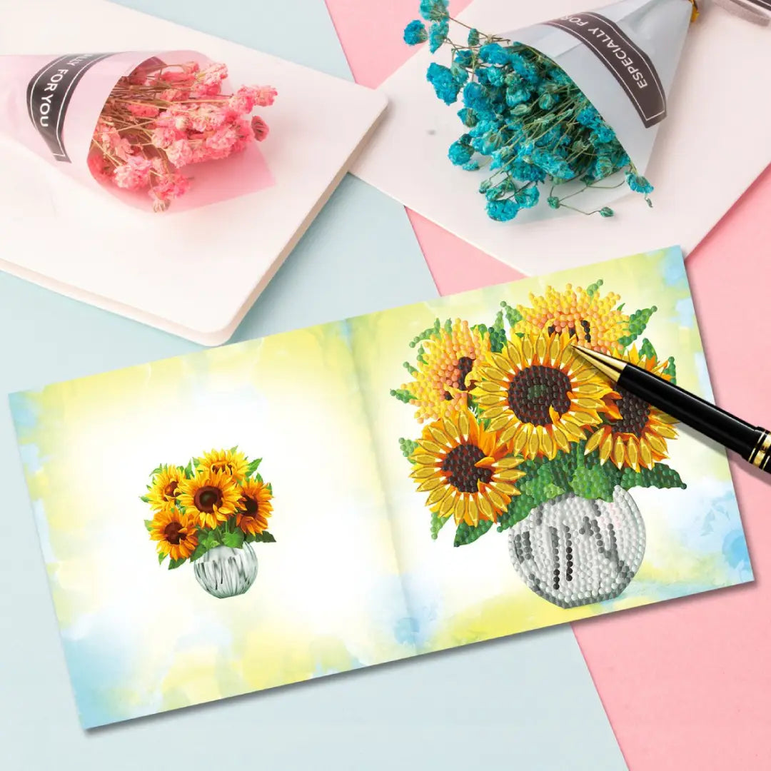 Diamond painting van zonnebloemen op kaart met pen en bloemen in de achtergrond